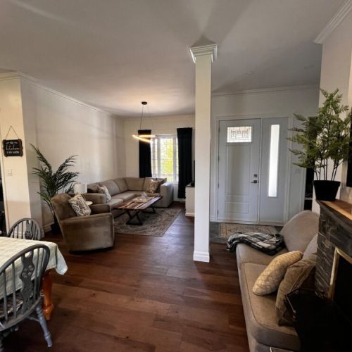 Bright and spacious living room with plenty of seating for relaxing or gathering with family and friends