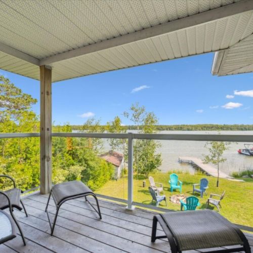 Upper entertainer’s deck with BBQ, outdoor dining, and sweeping water views — the perfect backdrop for sunrise coffee or sunset cocktails.
