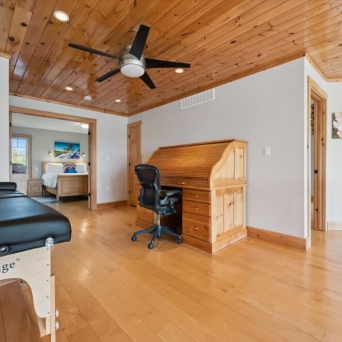 Open loft workspace and wellness area with soaring wood ceilings and natural light.