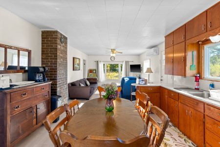 The open kitchen, dining and living areas create a welcoming central space for your stay at Smith Homestead.