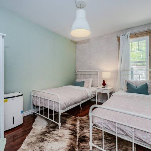 Bright and cozy Guest room with two twin beds.
