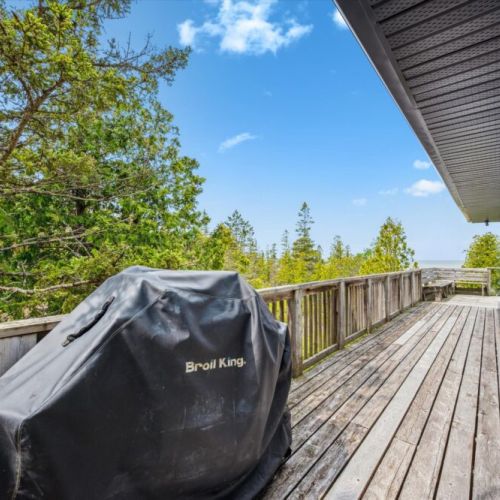 Fire up the grill on the side deck equipped with a Broil King BBQ — ideal for outdoor cooking after a day exploring nearby trails or beaches.