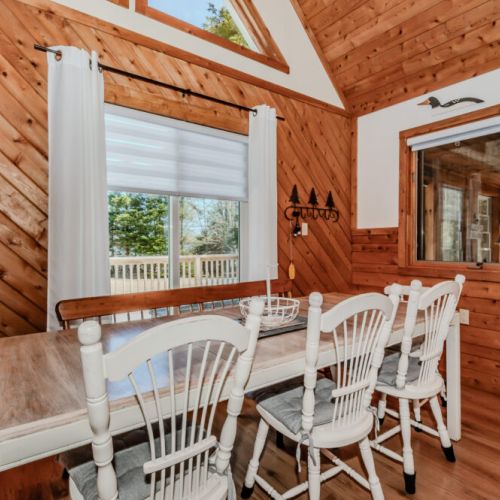 Charming dining nook with bright natural light and rustic cottage vibes — the perfect spot for family meals and lakeside memories.