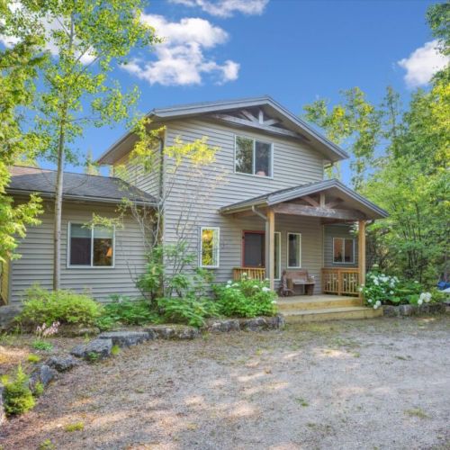 Inviting front entrance with covered porch and natural landscaping — a welcoming start to your Starry Night Retreat experience.