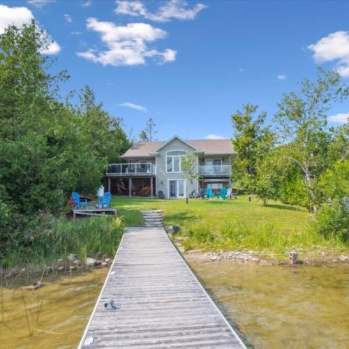 View from the dock looking back at the cottage — just steps from the water’s edge.
