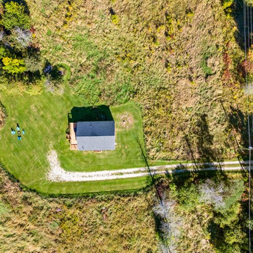 A bird’s-eye view of the private country setting, with a winding driveway leading to the homestead and plenty of green space to enjoy.
