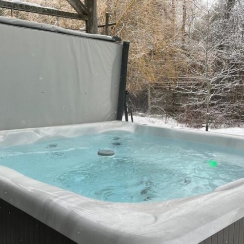 Nothing beats a winter hot-tub session here: warm water, crisp air, and a serene woods-side backdrop.