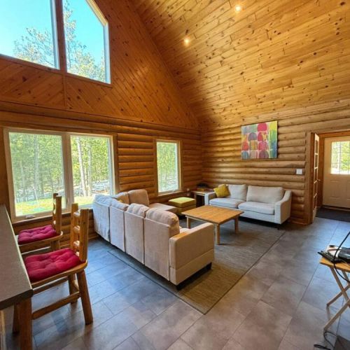 Step inside Blazed Inn, where the warmth of log walls and the luxury of radiant heated floors create a cozy retreat on 20 acres of beautiful forest near the National Park.