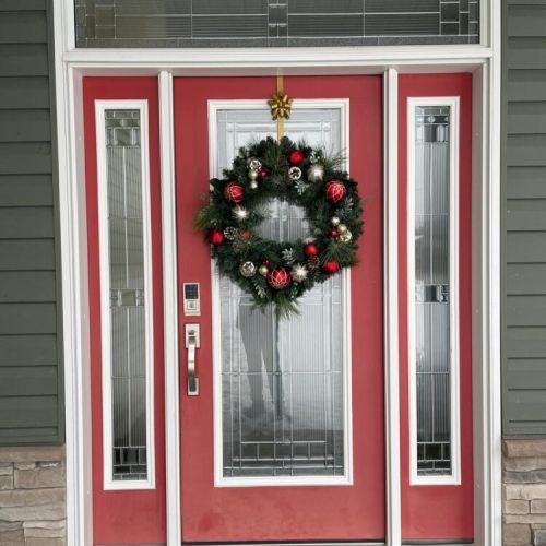 Welcome in from the cold through our bright red front door, dressed up for the season to make every arrival feel warm and festive.
