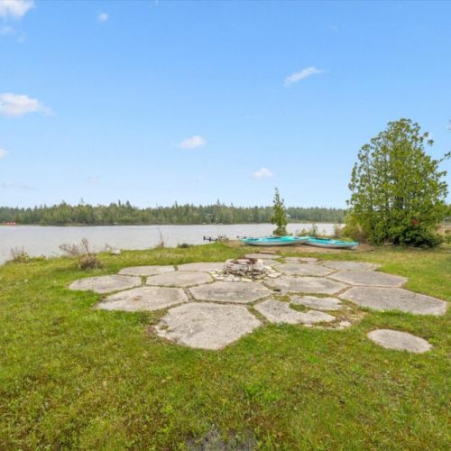 Gather around the fire pit under the stars while taking in peaceful waterfront views.