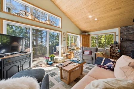 Curl up with a book, sip your morning coffee, or simply enjoy the tranquil views from this bright and inviting living space.