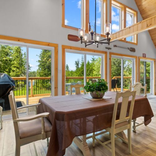Gather around the dining table while enjoying beautiful views through the floor-to-ceiling windows.