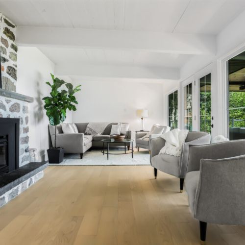 Warm inviting living space with comfy seating and a great view of the fireplace and lake side windows.