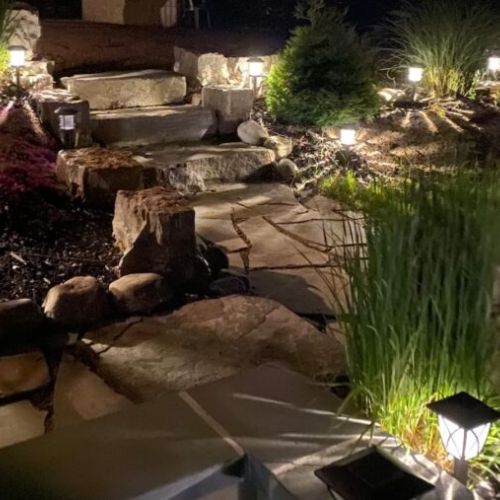 Solar lights surround the villa, providing a safe and well-lit environment at night near the hot tub and fire pit.