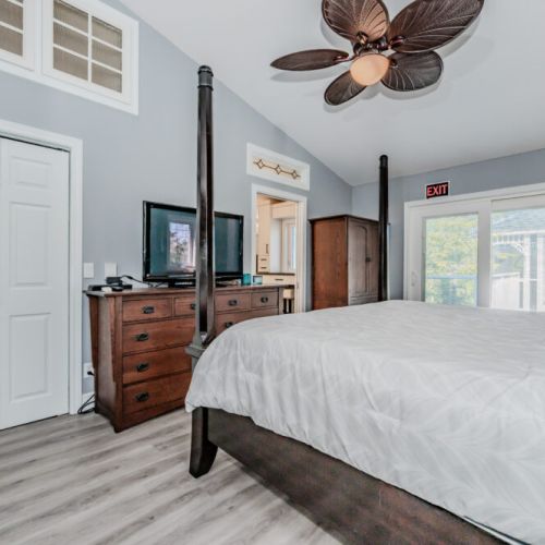 Gorgeous bedroom with a reclaimed wood feature wall, private deck access, and modern finishes—your peaceful retreat.