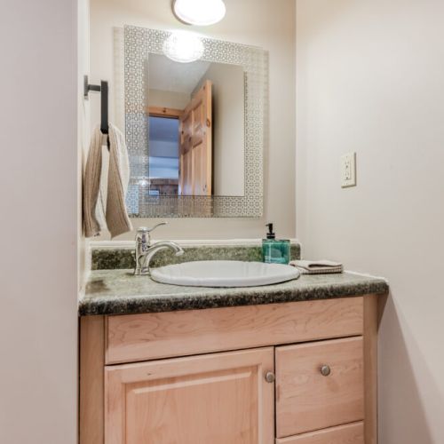 Cozy guest washroom with custom mirror and homey touches—your vacation comfort is top priority.