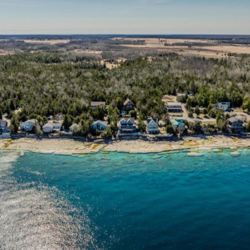 Sweeping shoreline vista framed by pristine blue waters and rugged natural beauty—ideal for kayaking, peaceful reflection, and nature-inspired escapes.