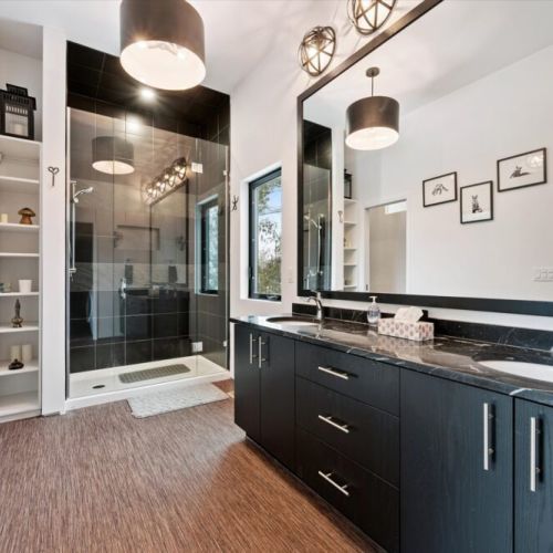 A modern, spa-inspired bathroom featuring a double vanity, glass walk-in shower, and clean finishes that feel bright and calming.