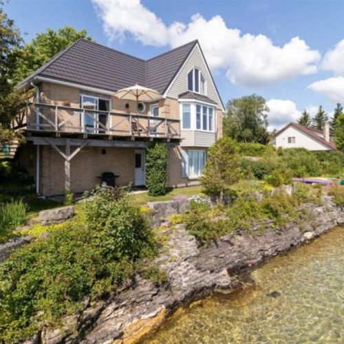 This beautiful 4-season home sits directly on Georgian Bay with crystal-clear waters just steps away from your door.