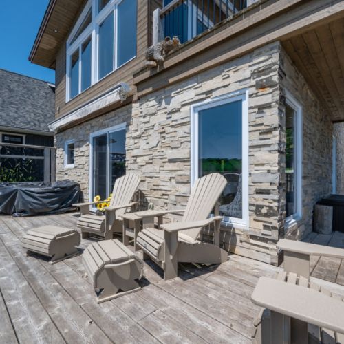 Outdoor lounge area with Adirondack chairs and direct access to the cottage.