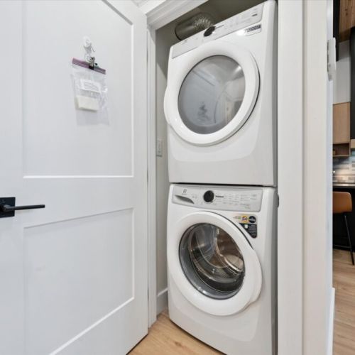 In-suite laundry with stacked washer and dryer for added convenience during longer stays.