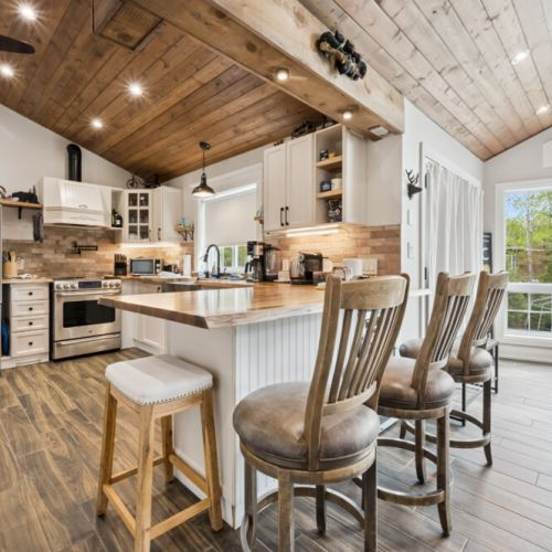 Cozy rustic peninsula seating faces the kitchen and dining area, creating the perfect gathering spot. Oversized, ultra-comfortable island chairs invite you to relax, connect, and enjoy everyday moments with family and friends.
