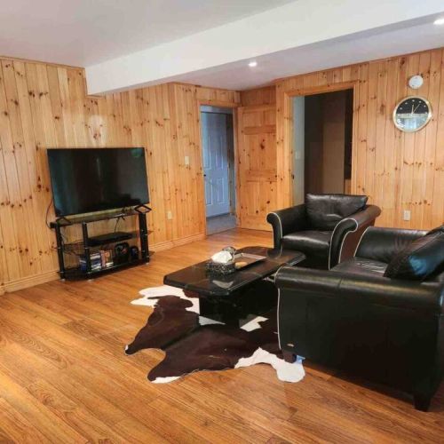 Kick back in the comfy lounge with leather seating and a flat-screen TV—great for movie nights or relaxing after a day of outdoor adventure.
