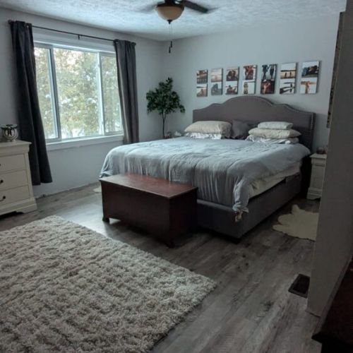 Bedroom 1: Comfortable bedroom with large windows, soft lighting, and peaceful views.