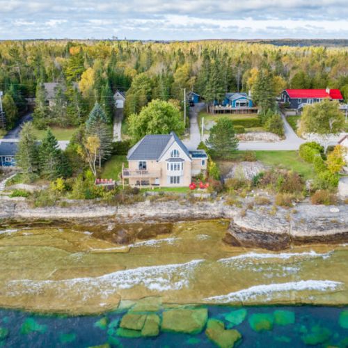 Aerial view of the property and surrounding area, nestled along the stunning coastline.