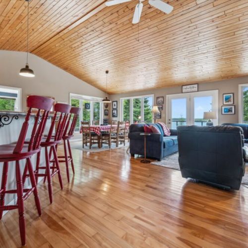 Open-concept living makes it easy to cook, dine, and relax together with bright natural light and warm wood finishes.