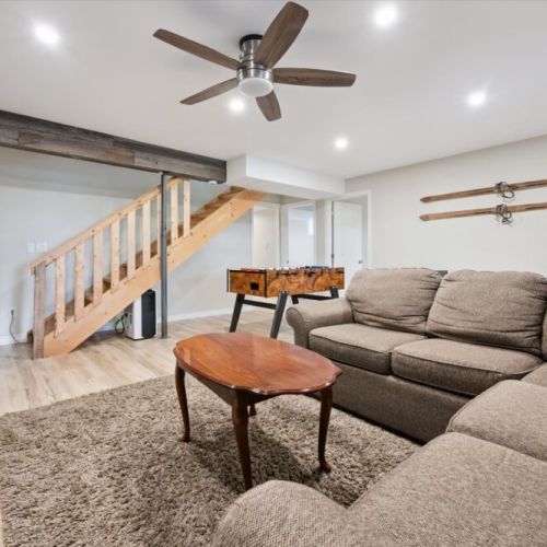 The lower-level family room offers a cozy space for movie nights, games, and indoor fun.