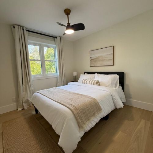 Wake up to natural beauty in this serene cottage bedroom, thoughtfully designed for your comfort and relaxation.