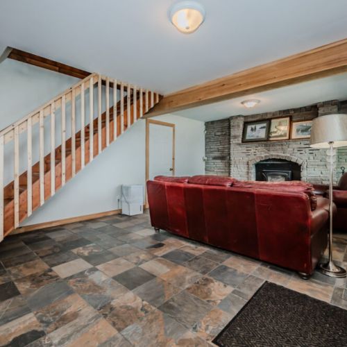 Spend your evenings by the fire in this spacious basement, a perfect spot for storytelling and board games.