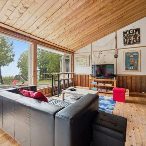 Bright and comfortable living space with cozy seating—perfect for relaxing after a day by the lake.