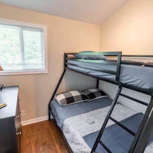 Bright and cozy second bedroom with a double/twin bunk bed — a fun and comfortable space for kids or extra guests.