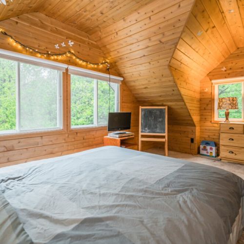Gorgeous wood panelling lines the upstairs guest bedroom.