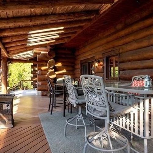 Gather on the spacious log porch — the perfect spot to dine, relax, and take in the fresh forest air.