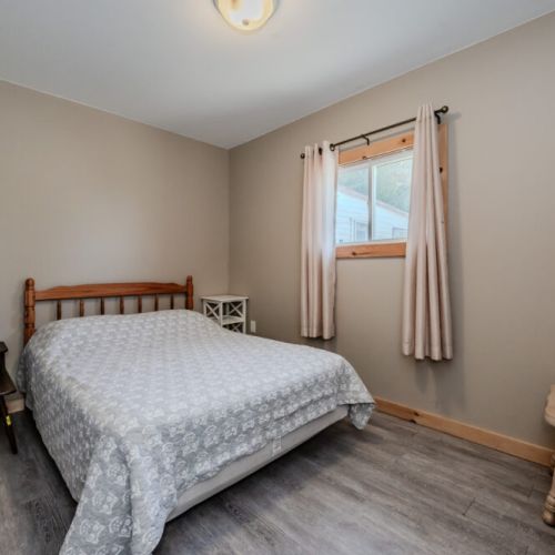 This bedroom features a comfortable bed, soft lighting, and simple decor, creating a peaceful space for rest.