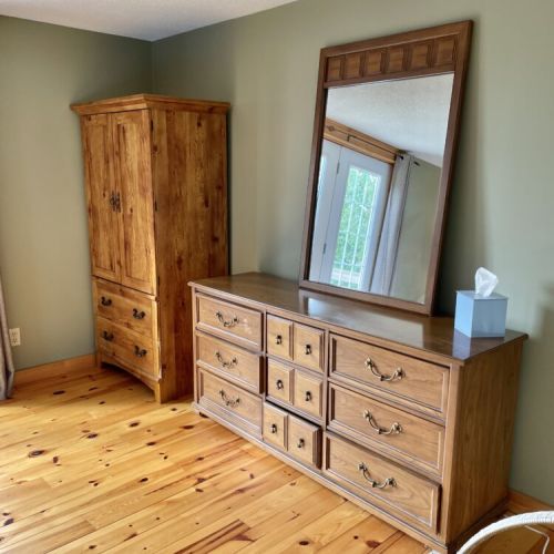 Bedroom 1: Spacious bedroom storage with dresser and closet space