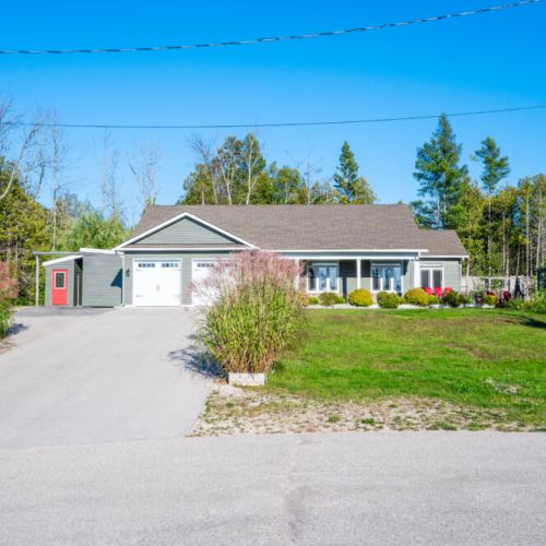 Spacious driveway, manicured lawn, and peaceful surroundings make this the ideal home base for your vacation.