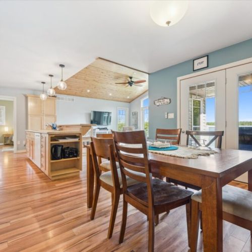 Bright dining area with lake views, open to the kitchen and living space for easy entertaining.