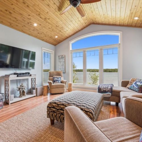 Cozy living room with stunning lake views through large picture windows.