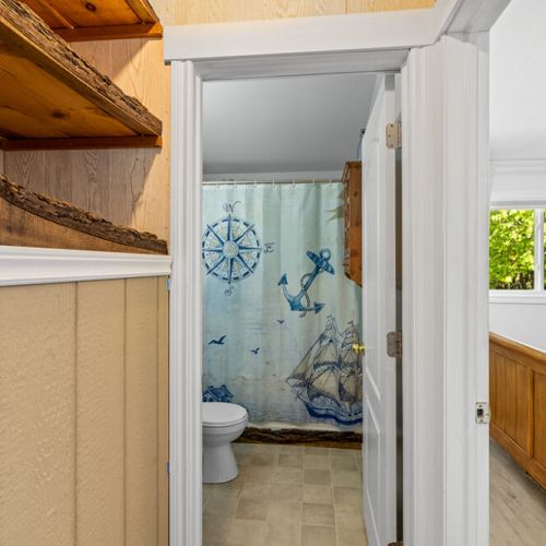 The bathroom is conveniently located between both bedrooms for easy access.