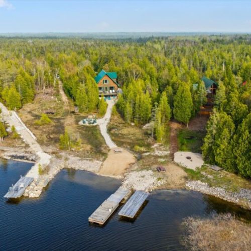 Explore the natural beauty of the coastline and nearby cottages from above.