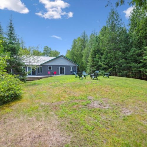Open green space meets forest privacy—perfect for games, relaxation, or simply soaking in the peaceful surroundings.