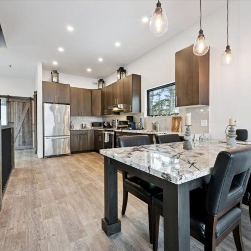 The kitchen and dining area come together seamlessly, offering a stylish space for cooking, shared meals, and lingering conversations.