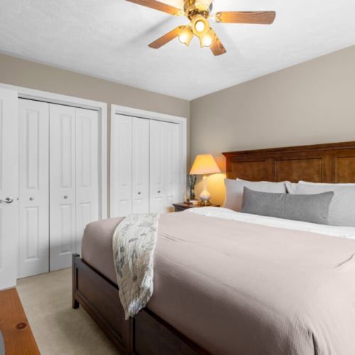 Rest comfortably in this welcoming king bedroom, featuring warm wood furnishings, soft bedding, and plenty of storage.