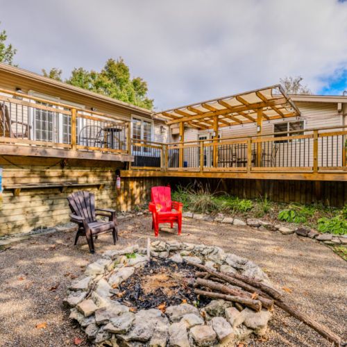 Relax on the spacious deck with comfortable seating and a pergola for shade, perfect for outdoor dining or simply enjoying the natural beauty.