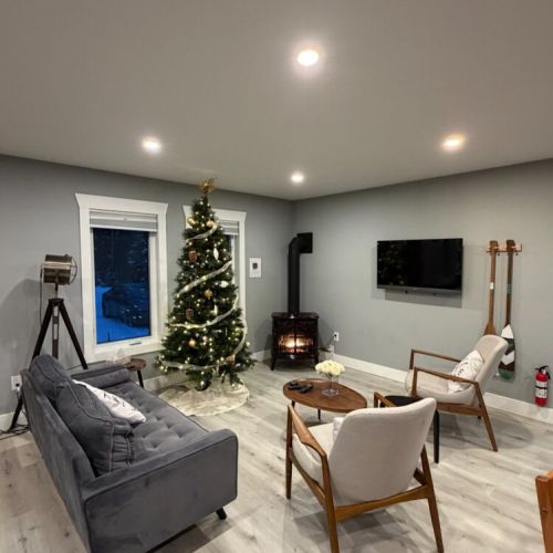 Holiday-ready at Sunset Bay with a warm glow, a twinkling tree, and fireside comfort. The kind of atmosphere that makes you want to stay in.