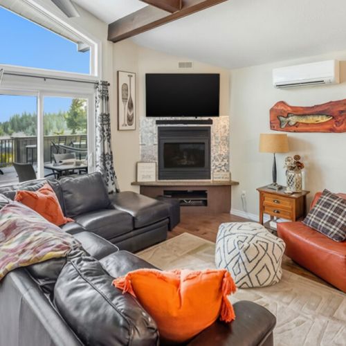 A bright living space with comfortable seating, fireplace, and scenic views. Designed for group travel and relaxed coastal stays.